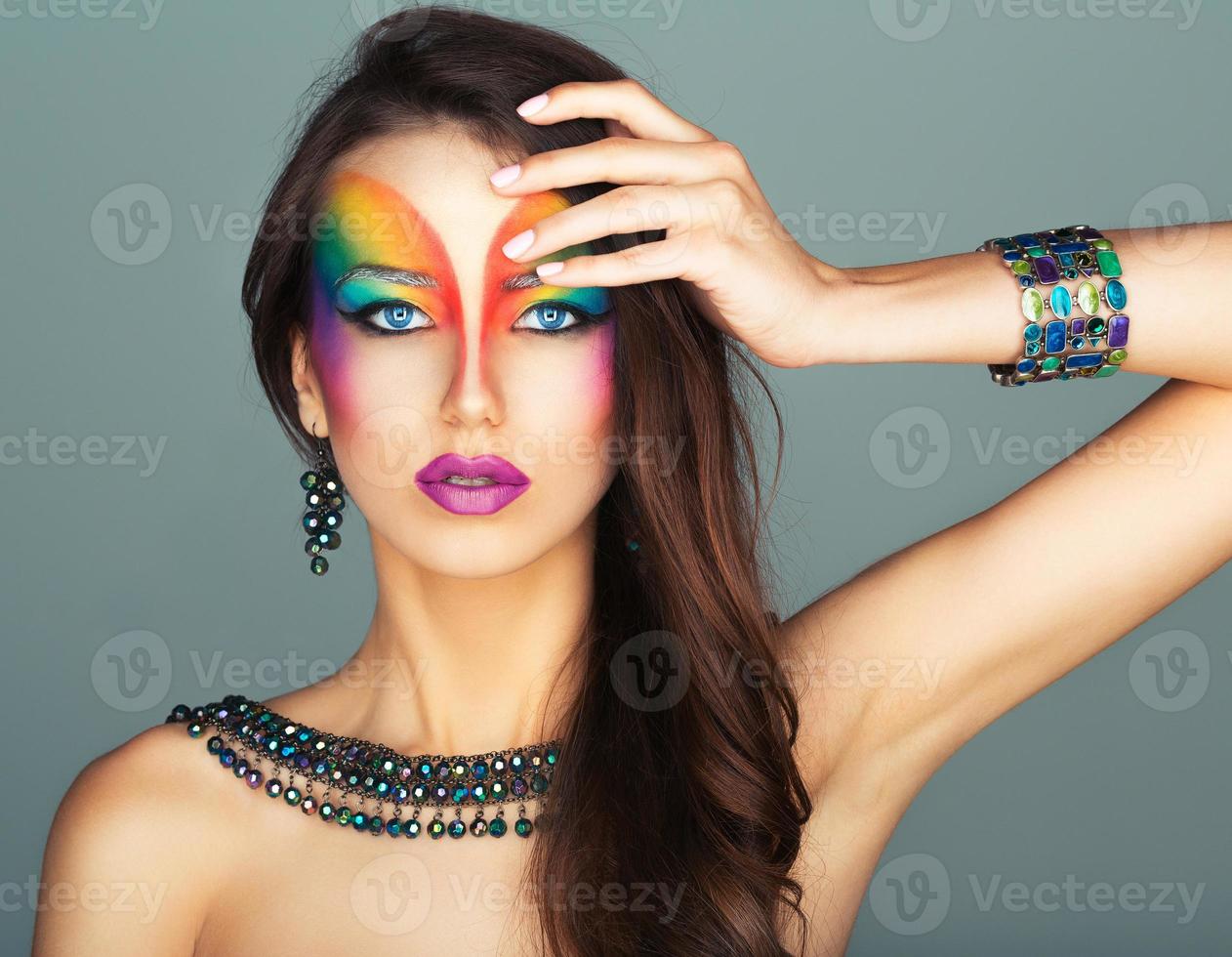 Portrait of a beautiful girl with a fashion bright multicolored makeup of eyes photo