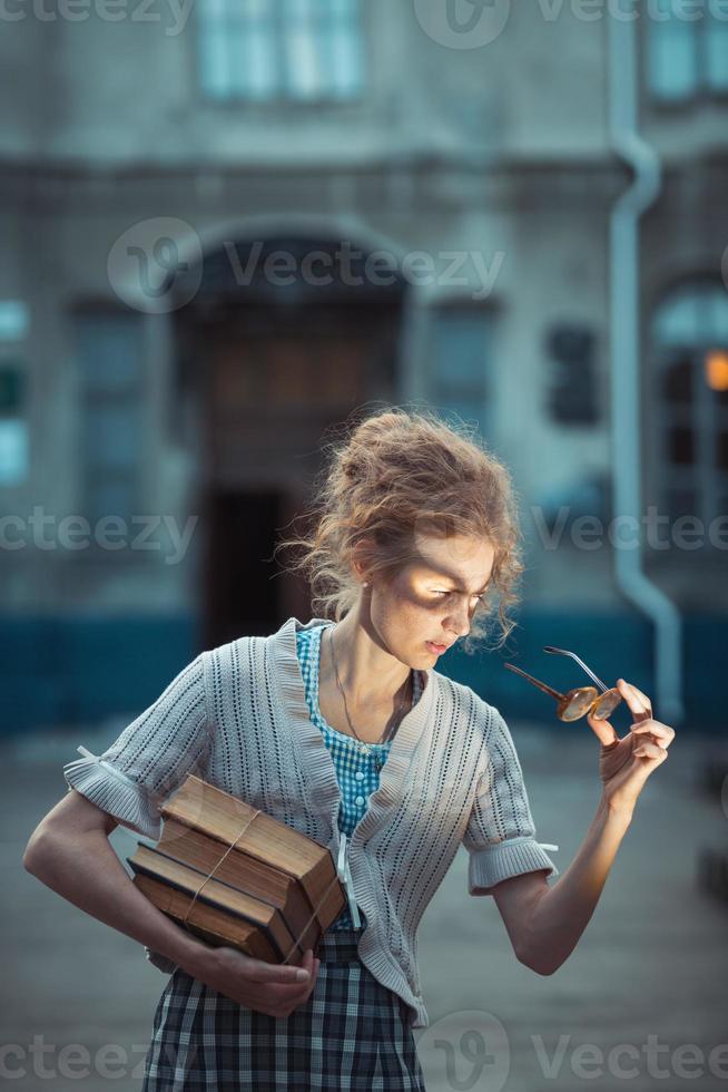 Funny girl with glasses and a vintage dress photo