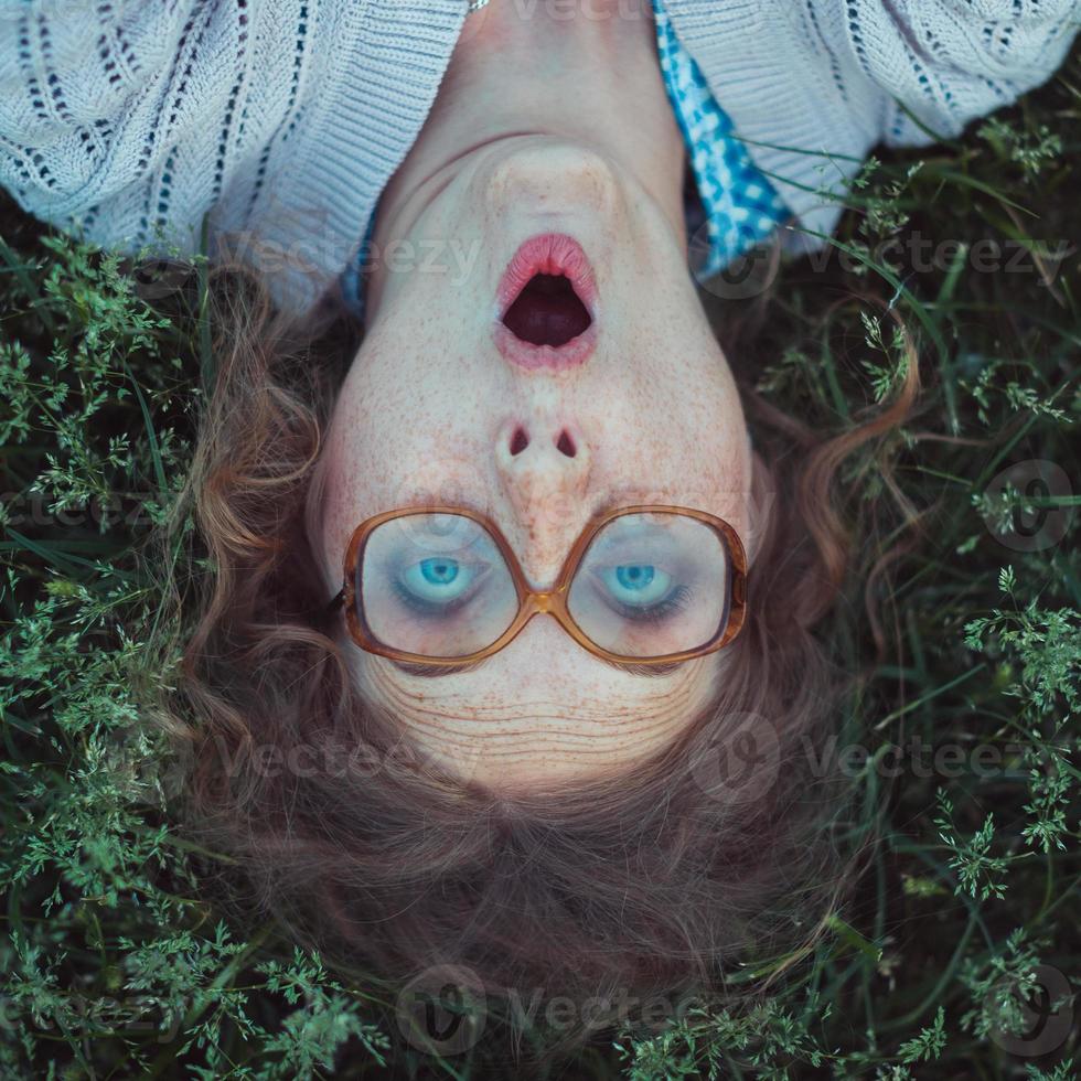 Funny girl with glasses and a vintage dress photo