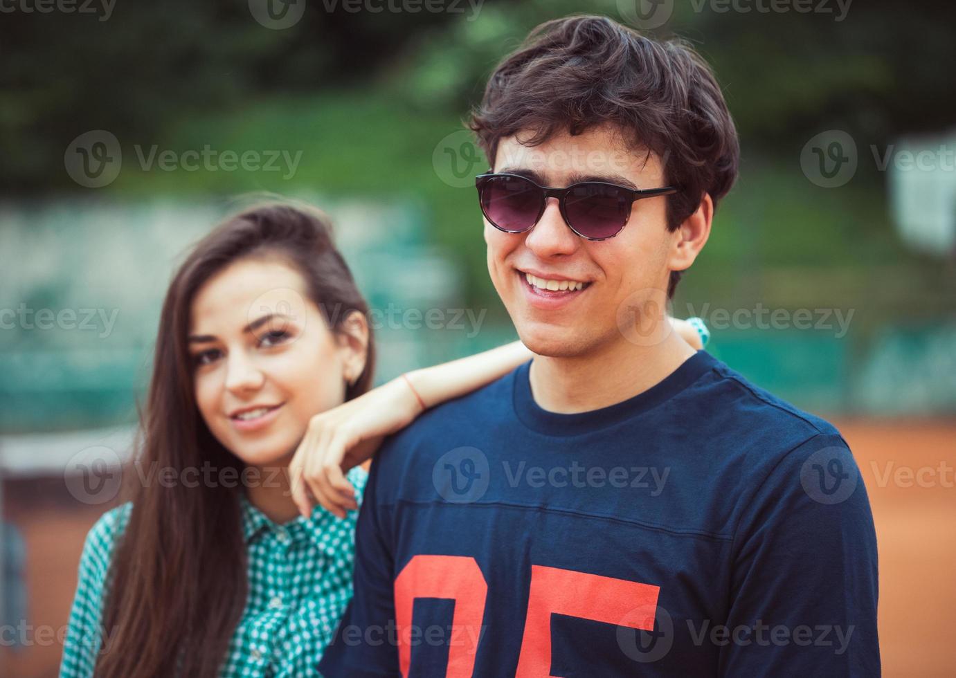 Young couple on the tennis court photo