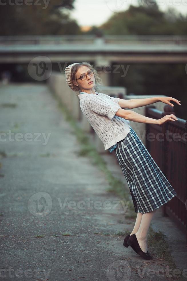 Funny girl with glasses and a vintage dress photo