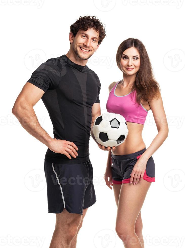 Athletic man and woman with ball on the white photo