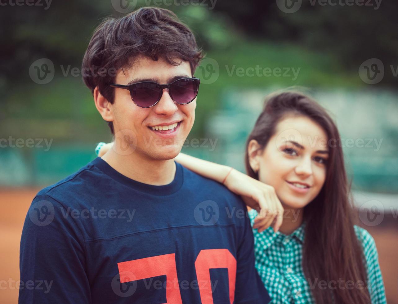 Young couple on the tennis court photo