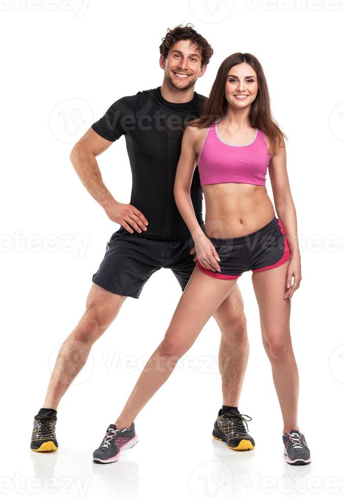 Athletic man and woman after fitness exercise on the white background photo