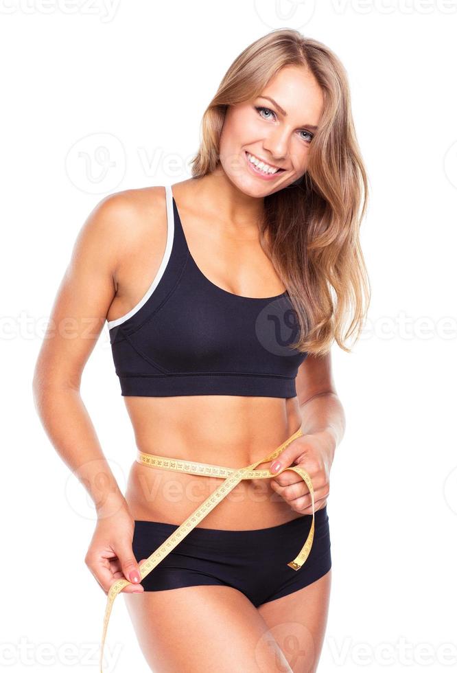 Portrait of attractive caucasian smiling woman with measuring tape isolated on white photo