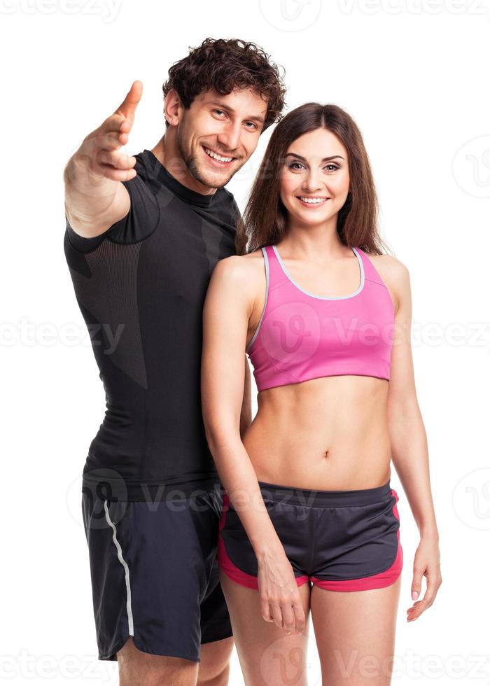 Athletic man and woman after fitness exercise on the white photo