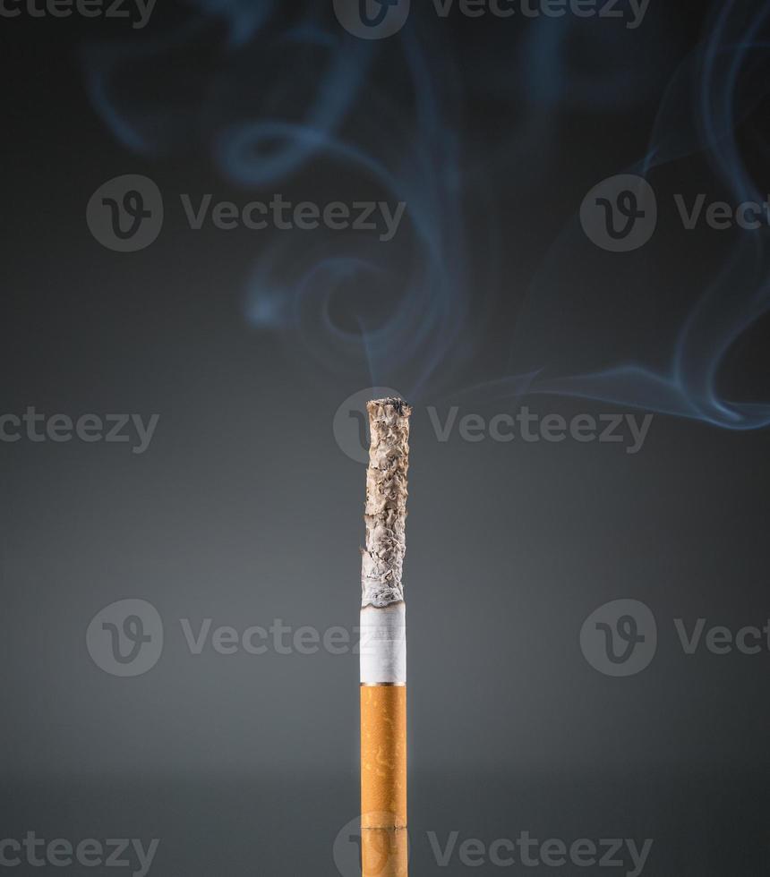 Smoking cigarette on black photo