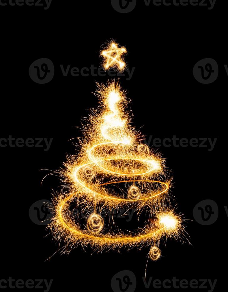 Christmas tree made by sparkler on a black photo