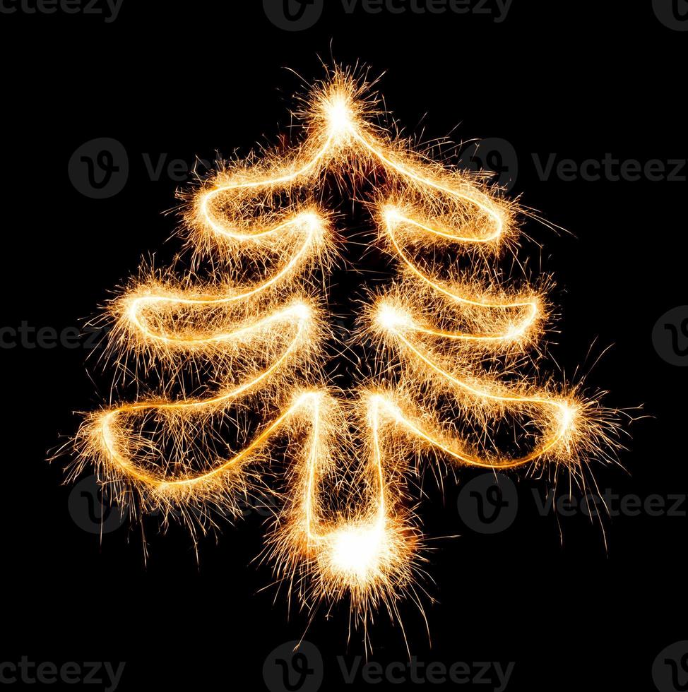 Christmas tree made by sparkler on a black photo