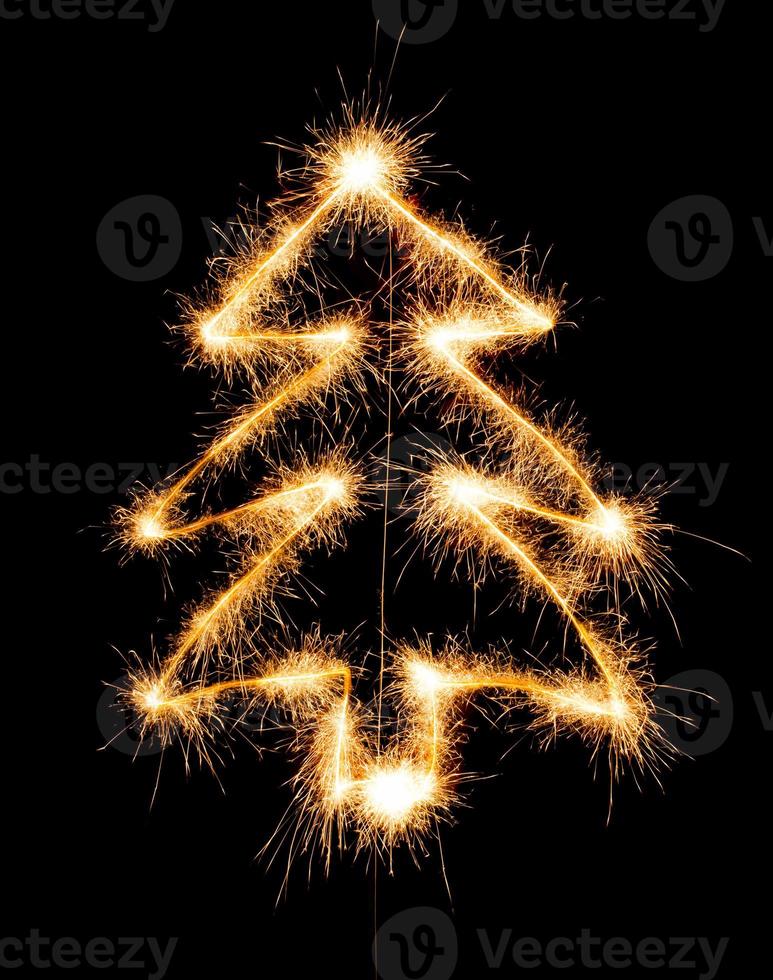 Christmas tree made by sparkler on a black photo