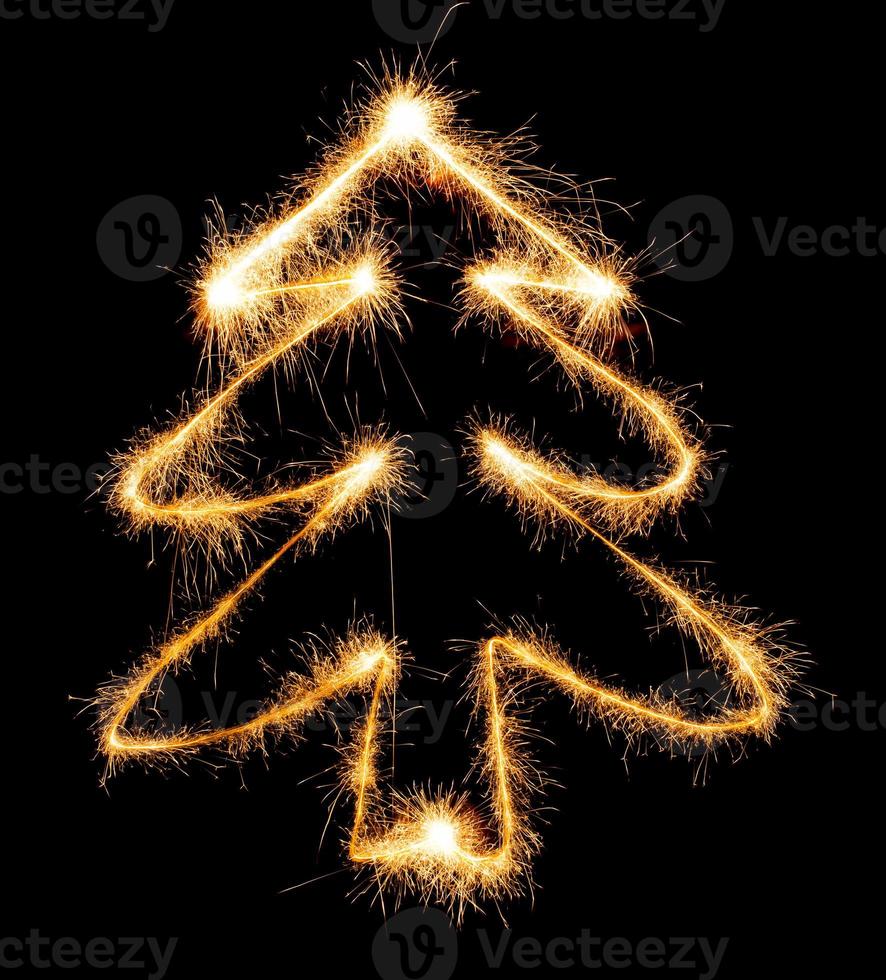 Christmas tree made by sparkler on a black photo