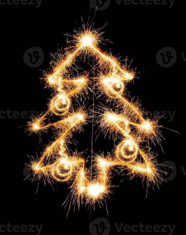 Christmas tree made by sparkler on a black photo