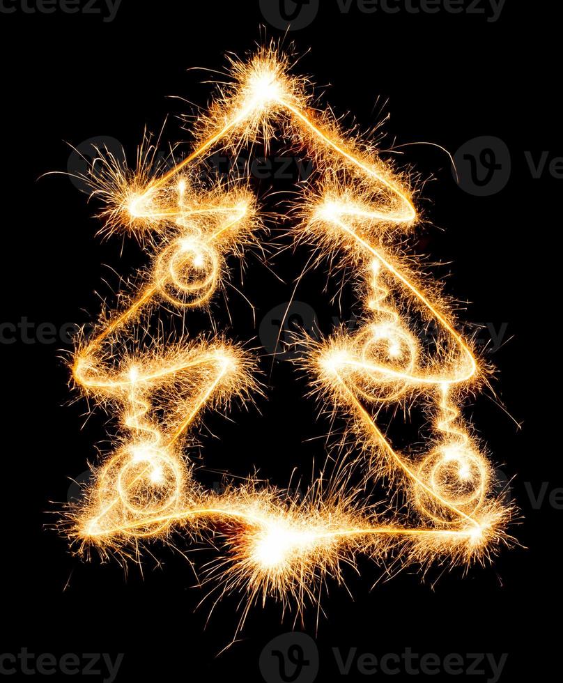 Christmas tree made by sparkler on a black photo