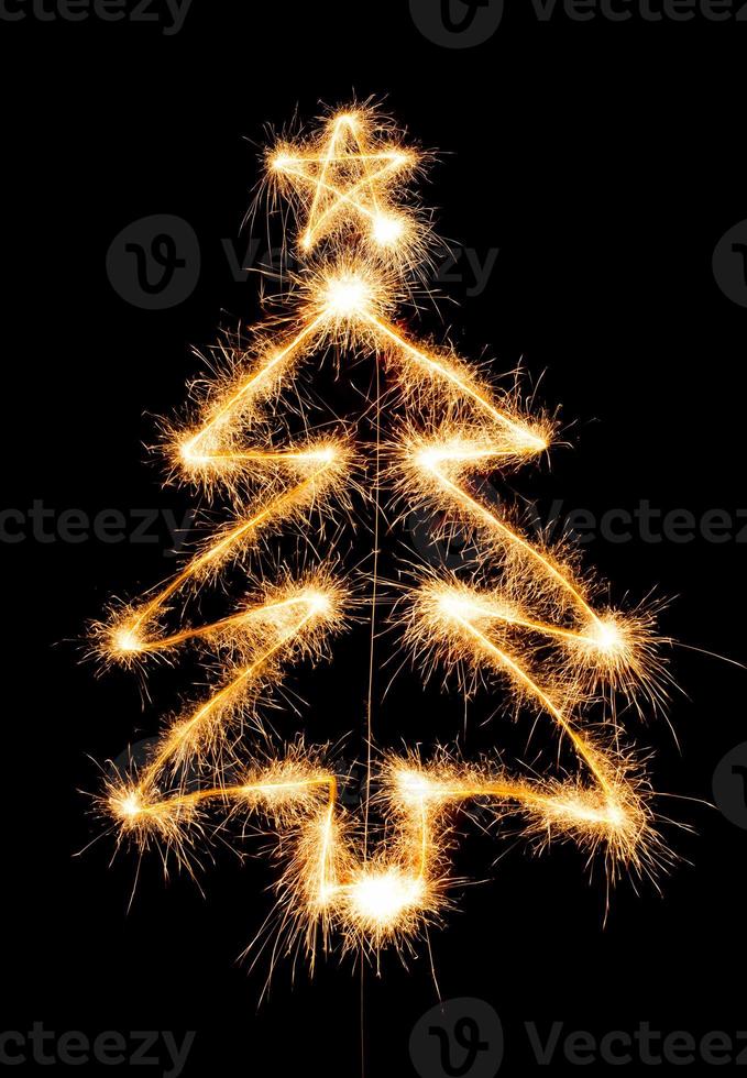 Christmas tree made by sparkler on a black photo