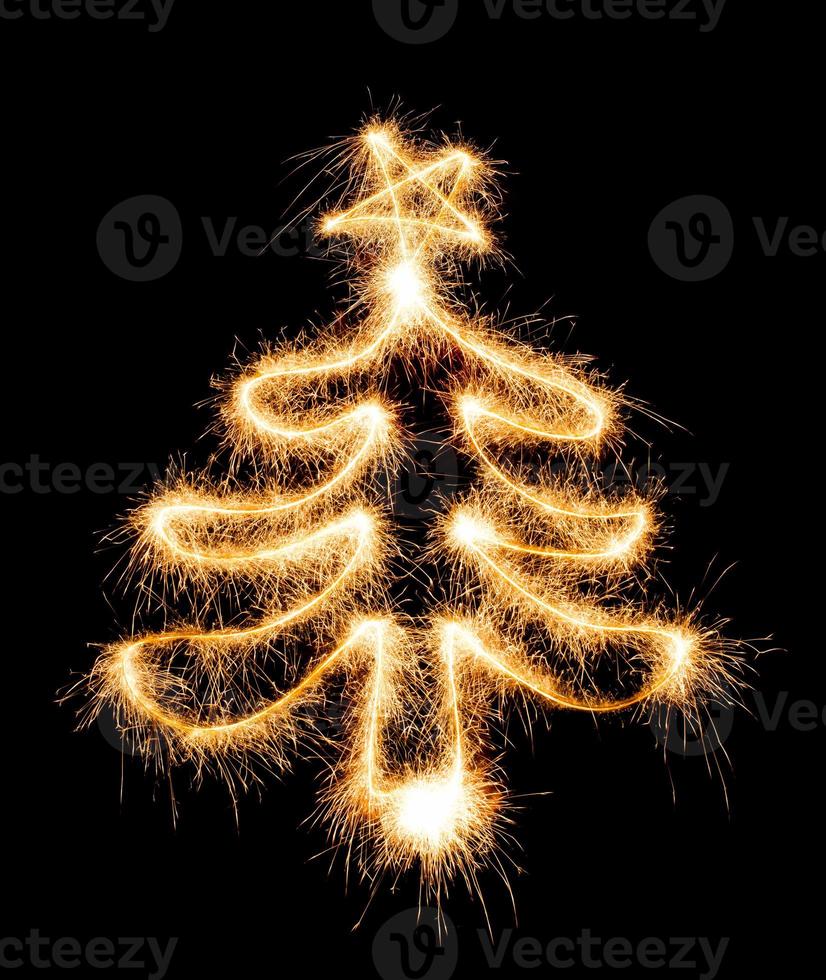 Christmas tree made by sparkler on a black photo