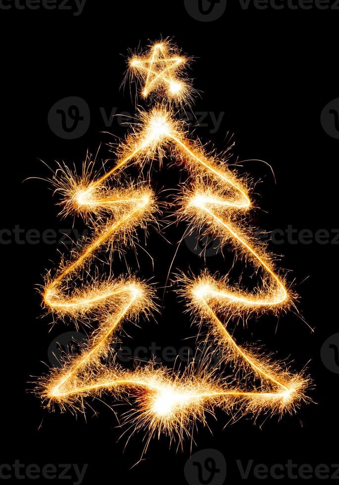 Christmas tree made by sparkler on a black photo