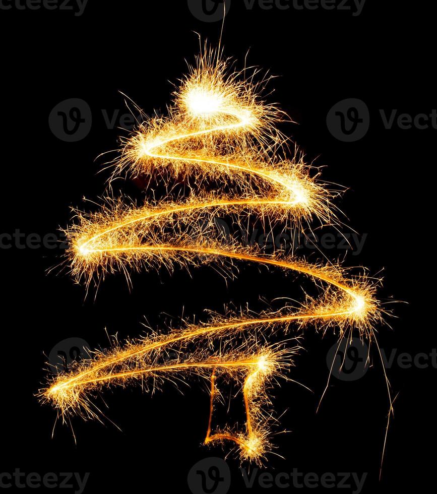 Christmas tree made by sparkler on a black photo