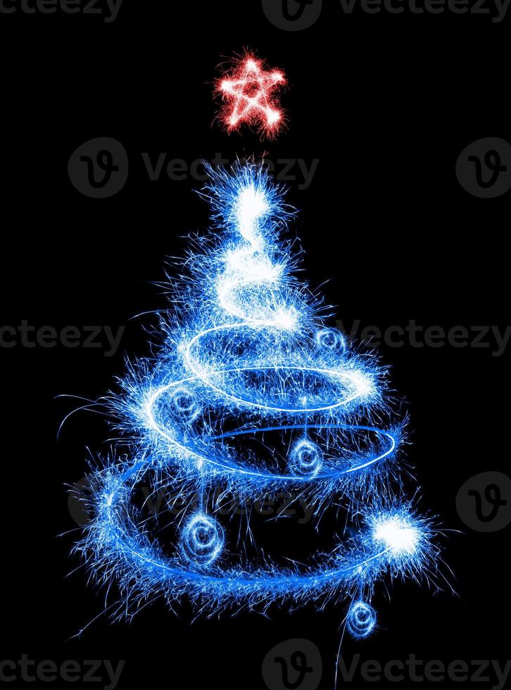 Christmas tree made by sparkler on a black photo