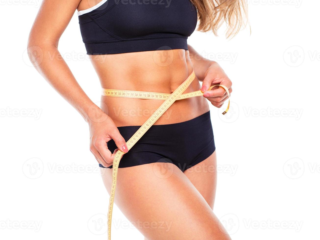 Woman measuring perfect shape of beautiful thigh photo