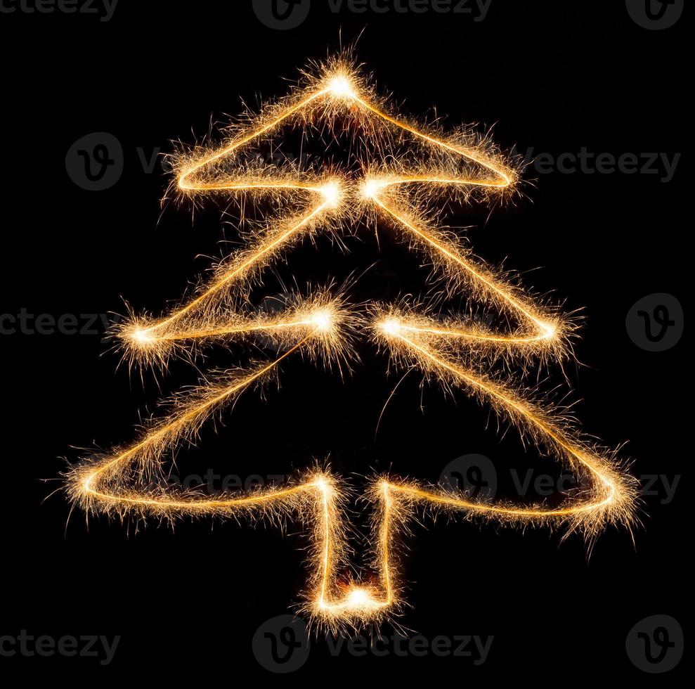 Christmas tree made by sparkler on a black photo