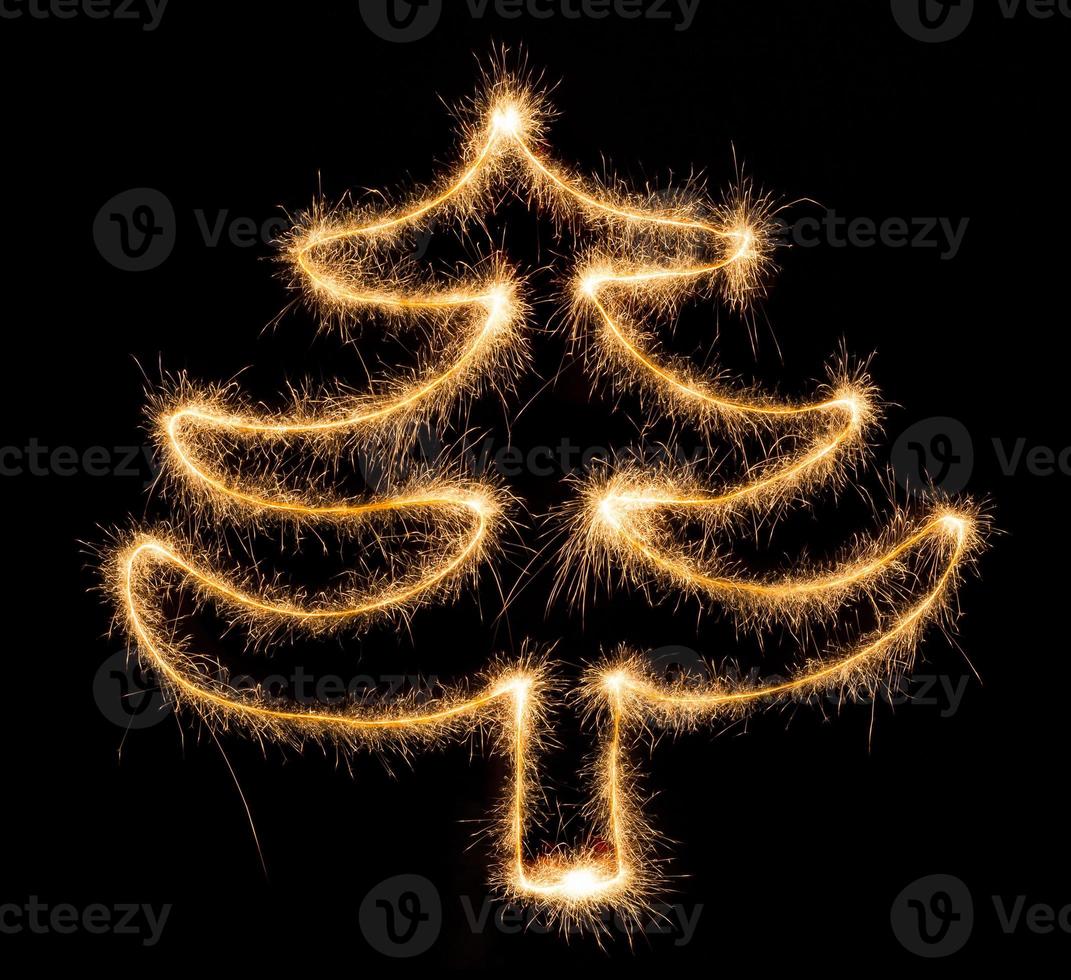 Christmas tree made by sparkler on a black photo