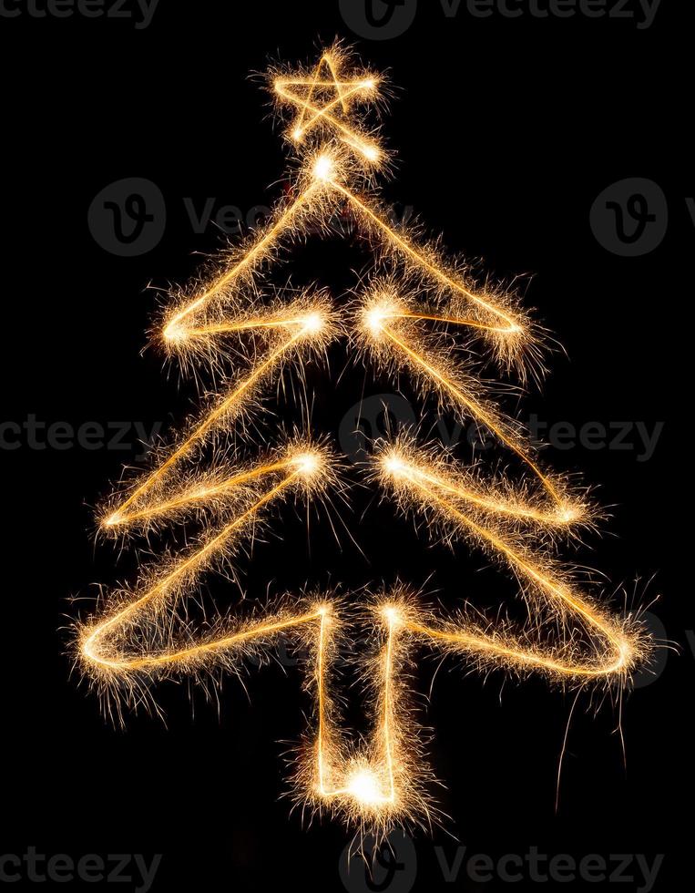 Christmas tree made by sparkler on a black photo