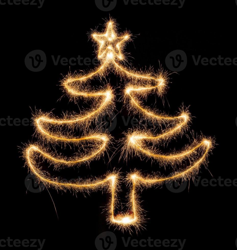 Christmas tree made by sparkler on a black photo