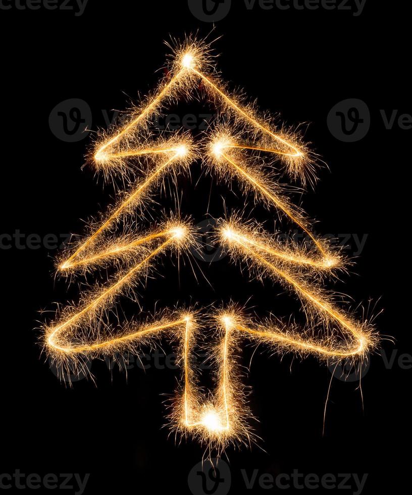 Christmas tree made by sparkler on a black photo