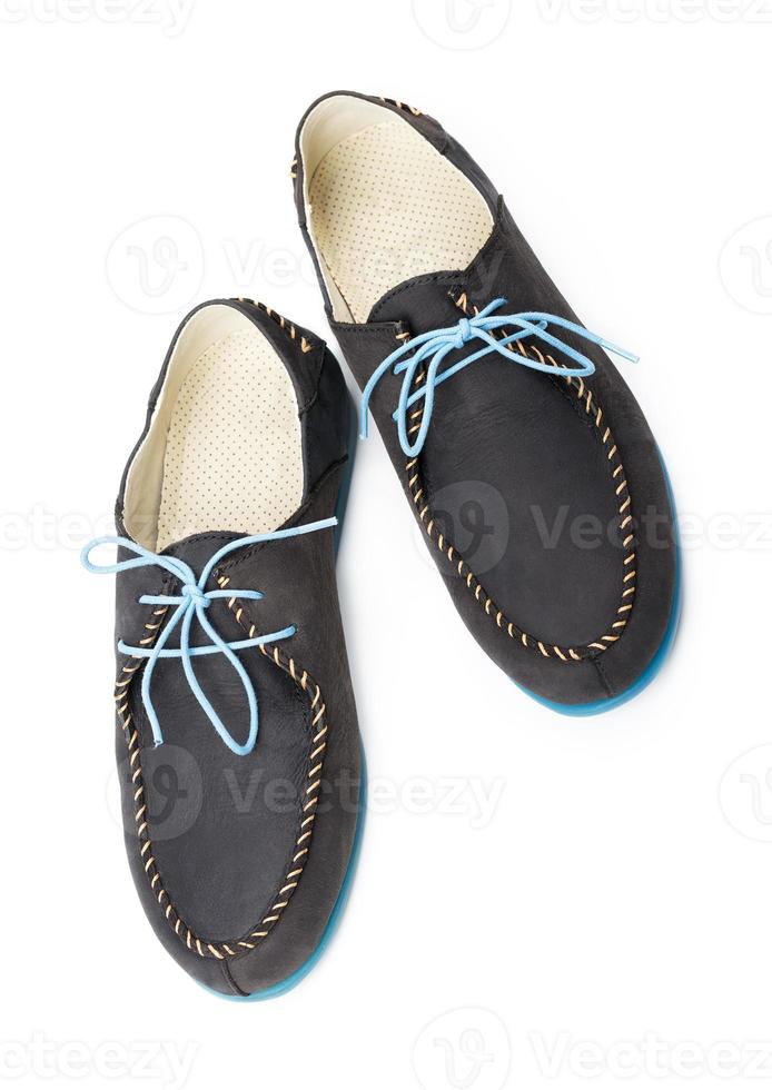 Black men's leather loafers with blue soles and laces on a white photo