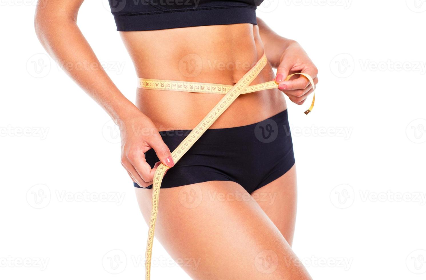 Woman measuring perfect shape of beautiful thigh, healthy lifestyles concept photo