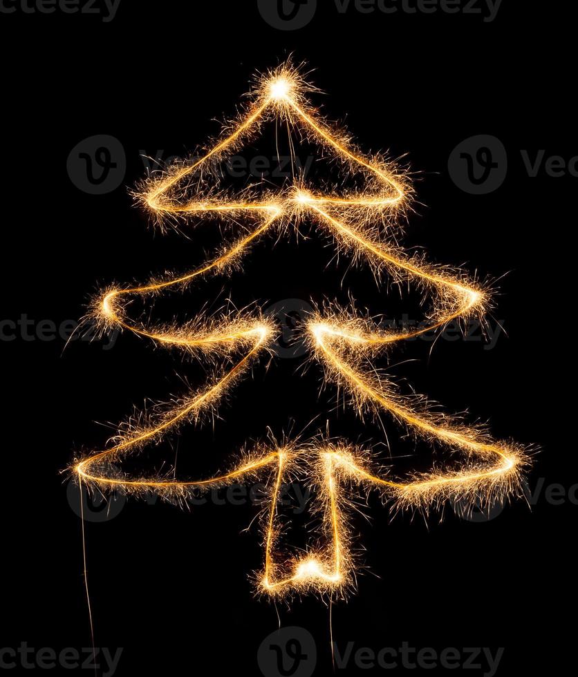 Christmas tree made by sparkler on a black photo