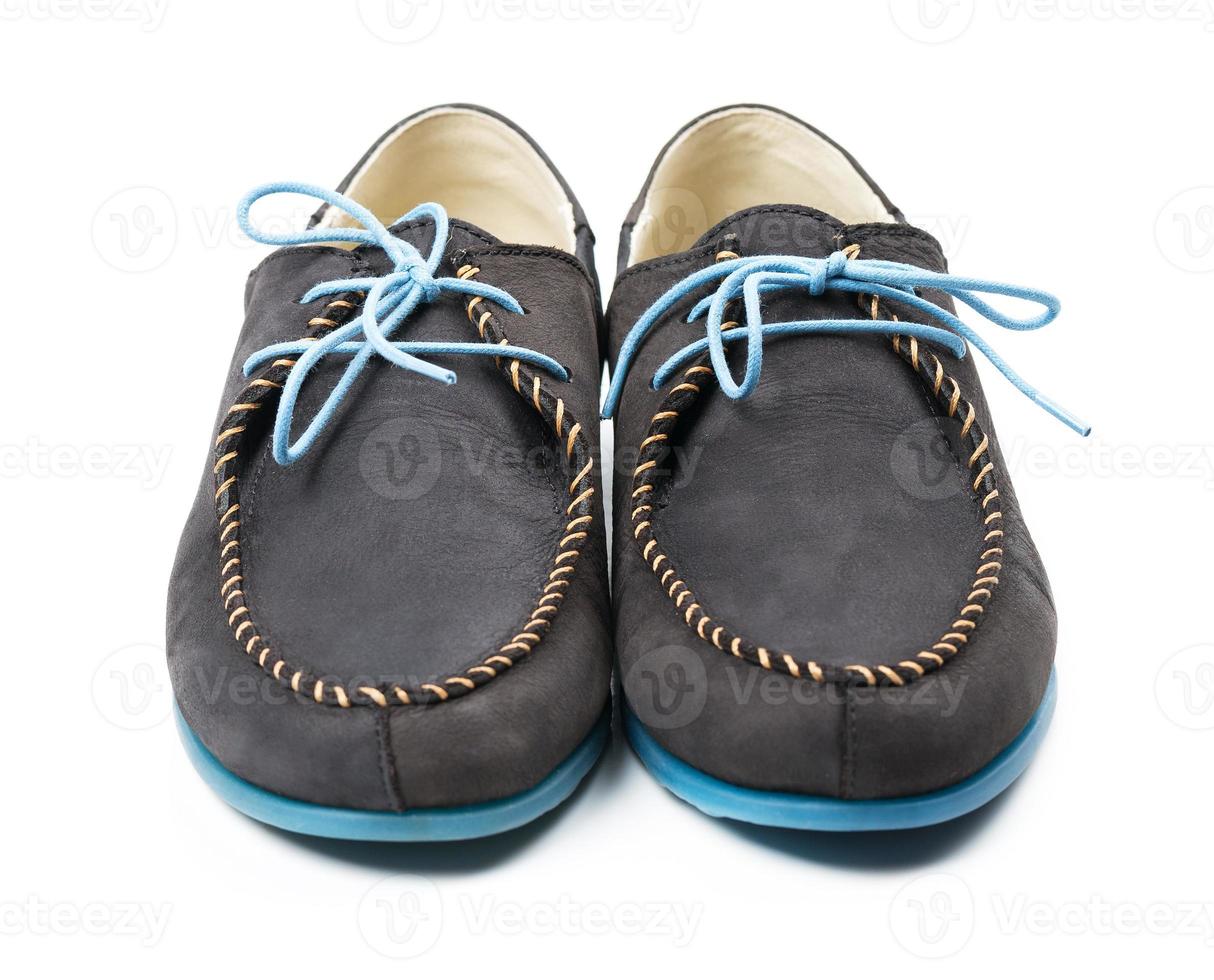 Black men's leather loafers with blue soles and laces on a white photo