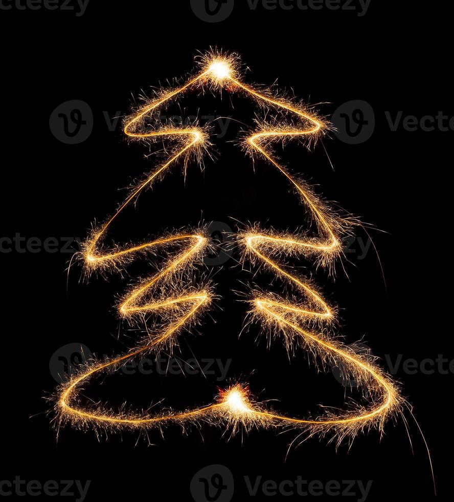 Christmas tree made by sparkler on a black photo