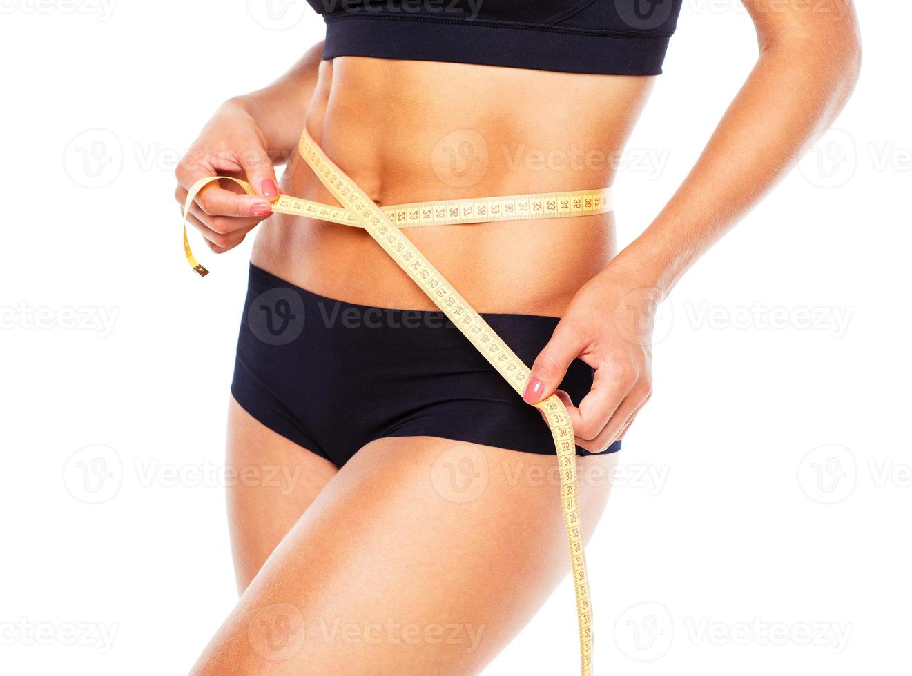 Woman measuring perfect shape of beautiful thigh photo