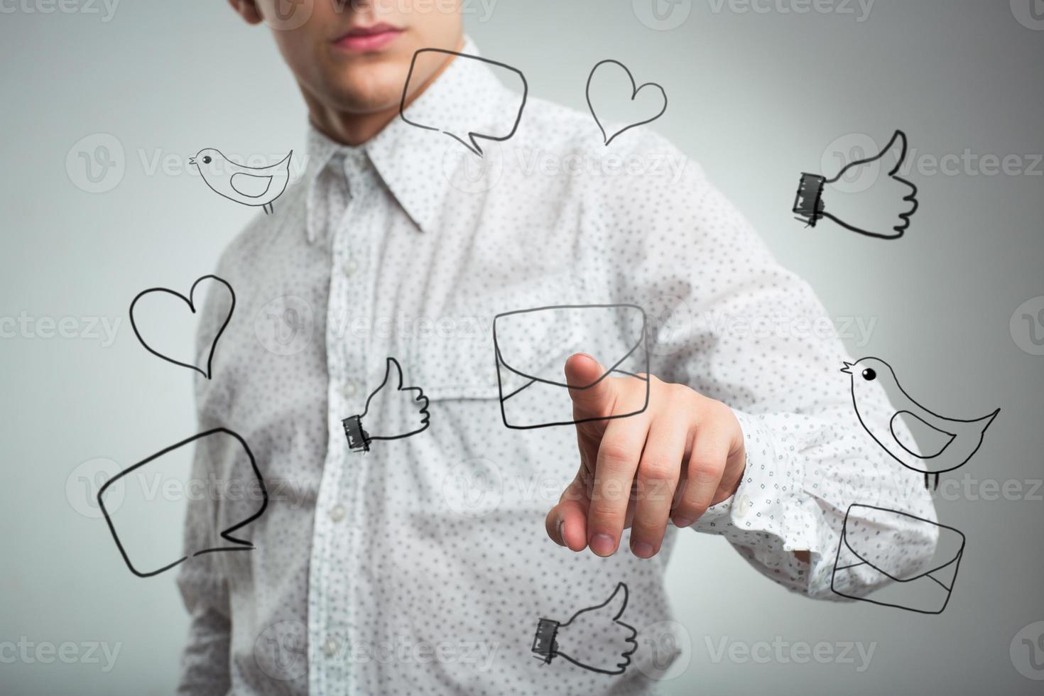 Man pressing a virtual icon mail in air photo