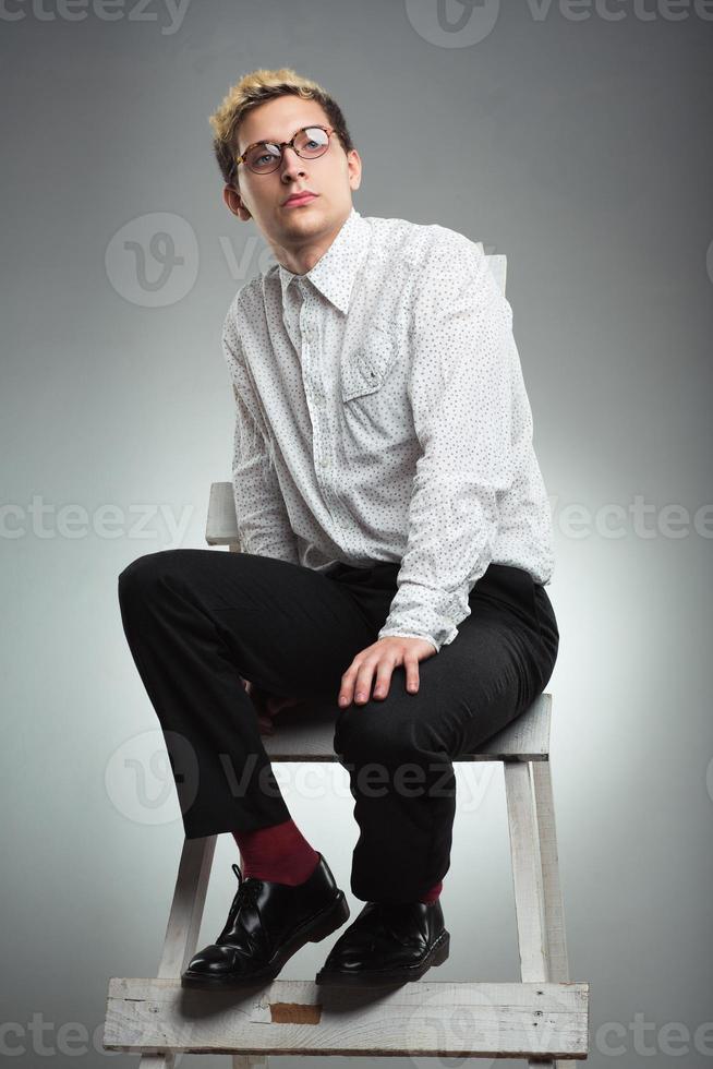 Young businessman looks into the distance in career ladder photo