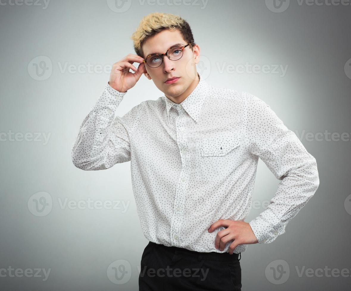 Young man looking to the camera wearing glasses photo