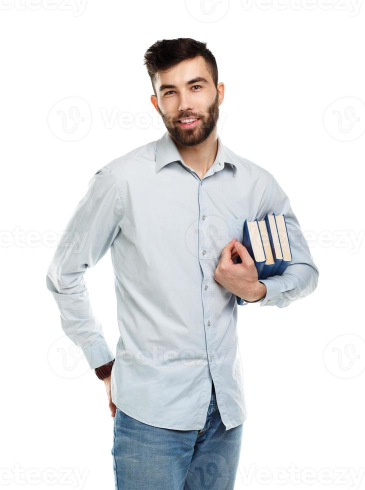 Young bearded smiling man with books in hands on white photo