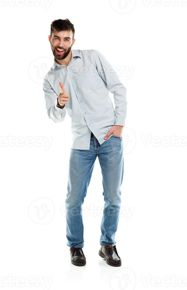 A young bearded man smiling with a finger up isolated on white photo