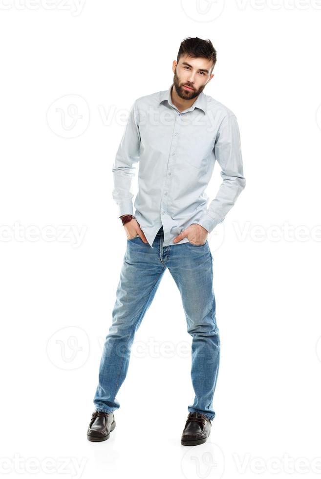 A young bearded man with a serious expression on his face isolated on white photo