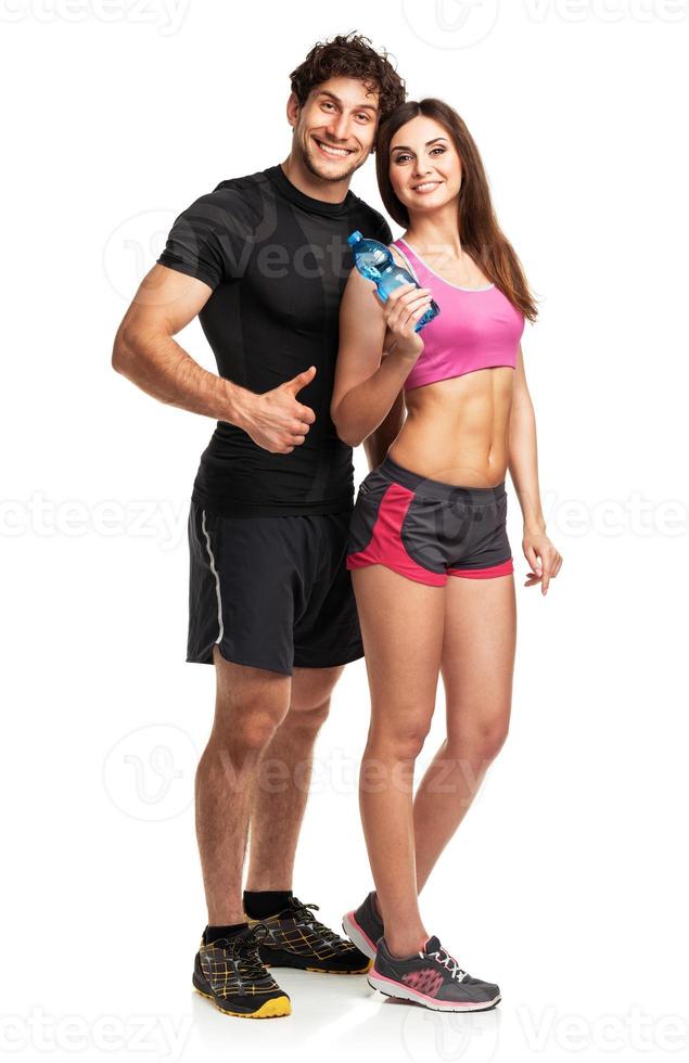 Athletic man and woman with bottle of water on the white photo