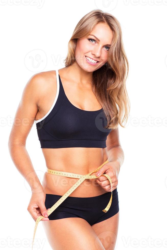 Portrait of attractive caucasian smiling woman with measuring tape photo