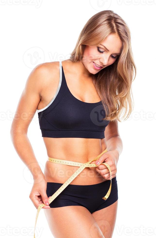 Portrait of attractive caucasian smiling woman with measuring tape photo