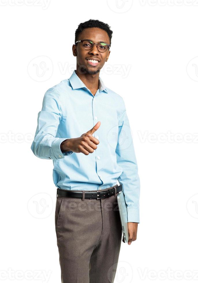 Happy african american college student standing with laptop and finger up on white photo