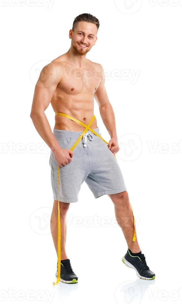 Athletic man with measuring tape on the white photo