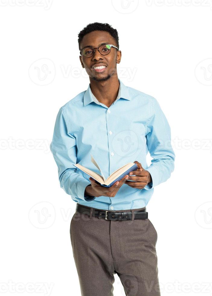 Happy african american college student standing with book on white photo