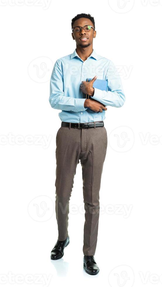 Happy african american college student standing with books in his hands on white photo