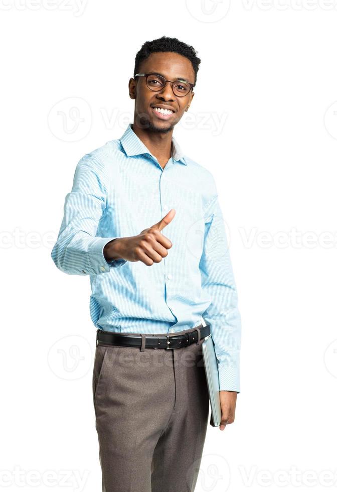 Happy african american college student standing with laptop and finger up on white photo