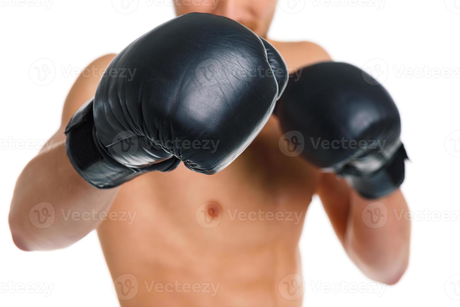 Athletic attractive man wearing boxing gloves on the white photo