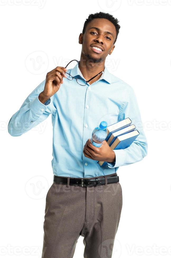 Happy african american college student standing with books in his hands on white photo